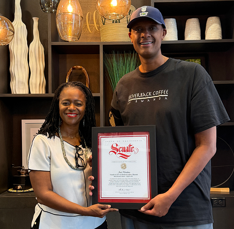 Senator Lola Smallwood-Cuevas presents a certficater to Jack Karuletwa, owner of Silverback Coffee of Rwanda.