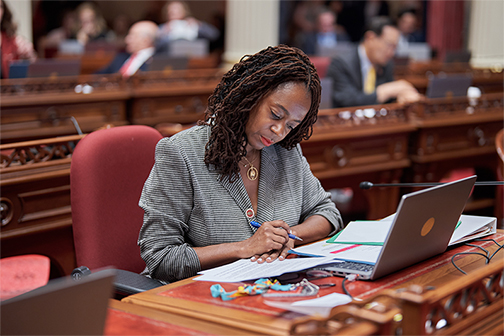 Senator Lola Smallwood-Cuevas is shown seated in the California Senate Chambers.