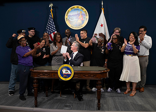 Governor Newsom is applauded by Senator Lola Smallwood-Cuevas and SEIU members during his recent bill signing of SB 1203—Stand for Security Act.